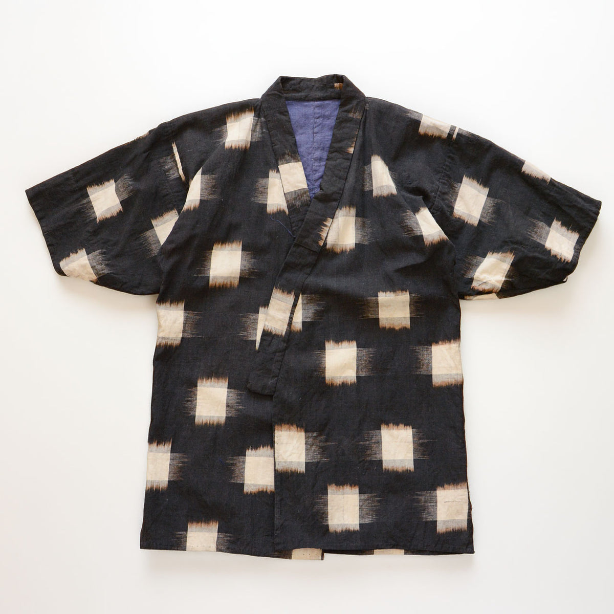 Early–mid Showa Japanese cotton noragi with large ecru kasuri motifs on a dark ground.