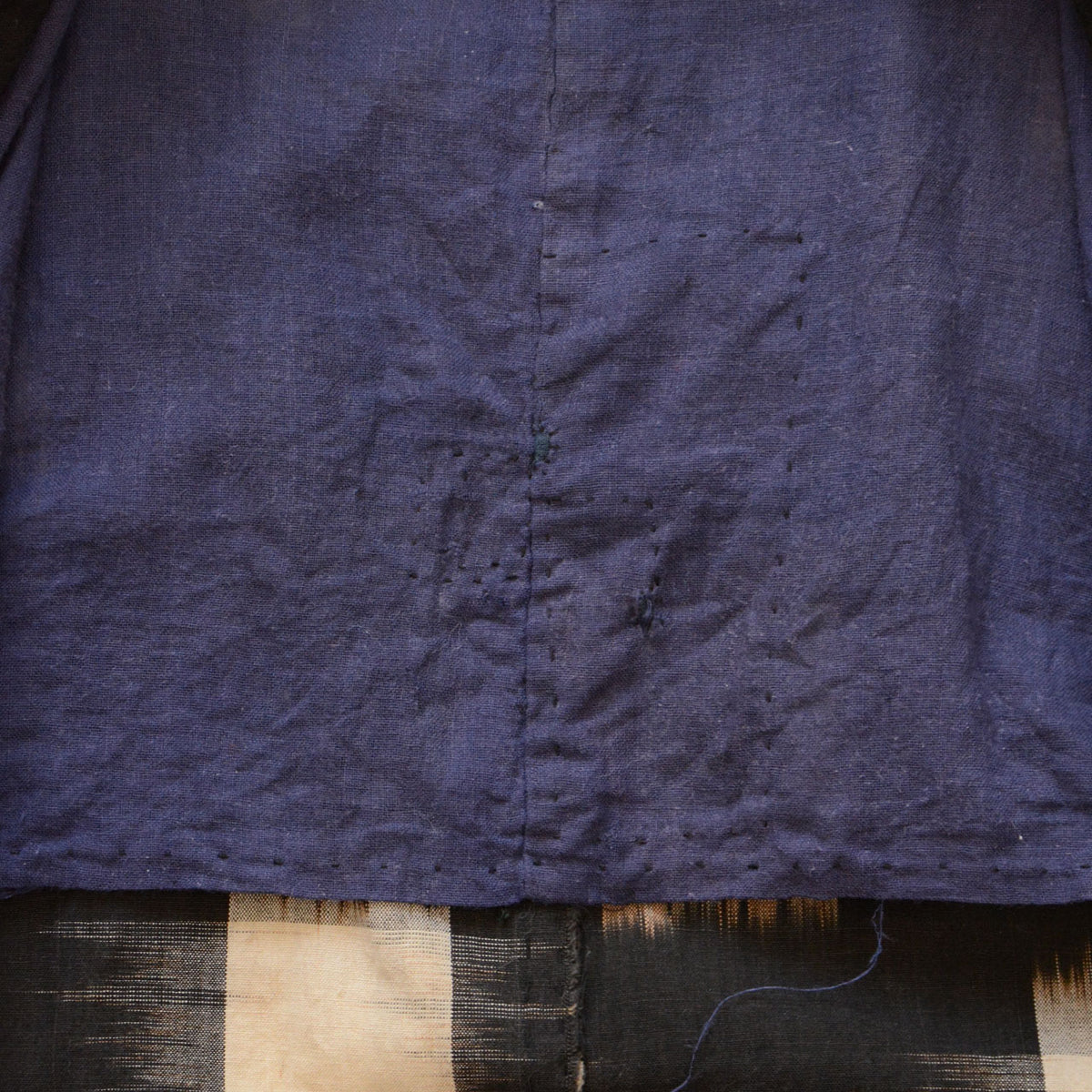 Navy-toned cotton noragi lining with a fine grid-like weave and small mended areas.