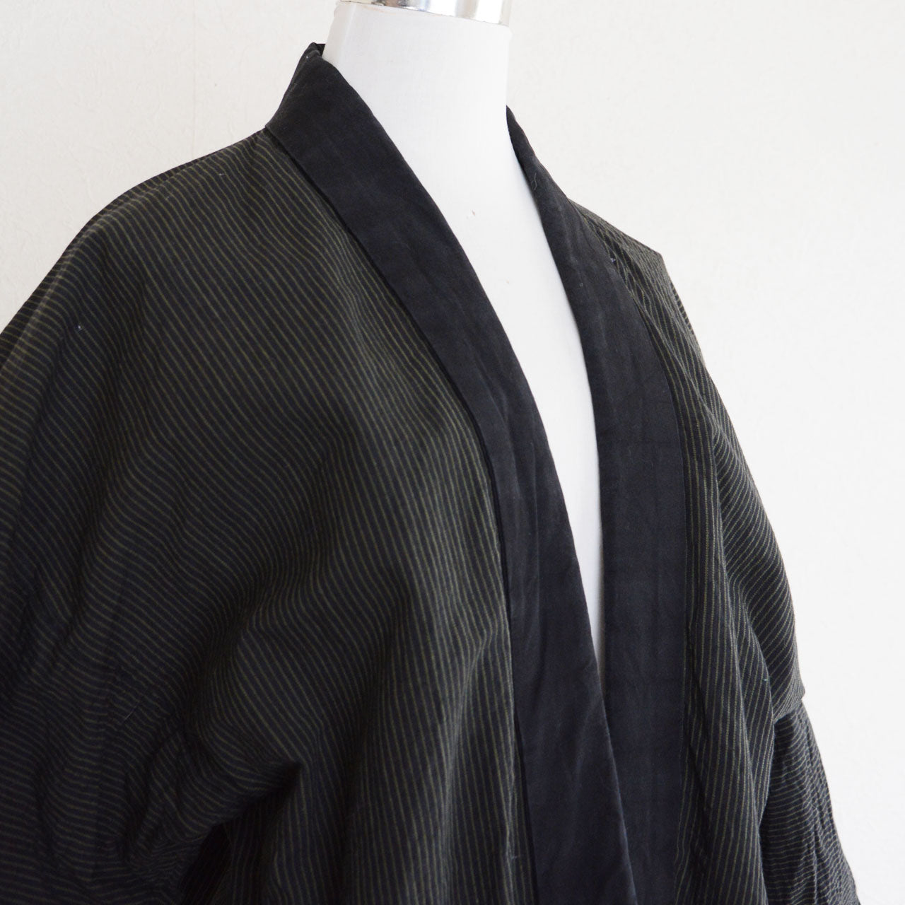 Showa era Japanese Noragi jacket highlighting striped cotton texture and hand-sewn character