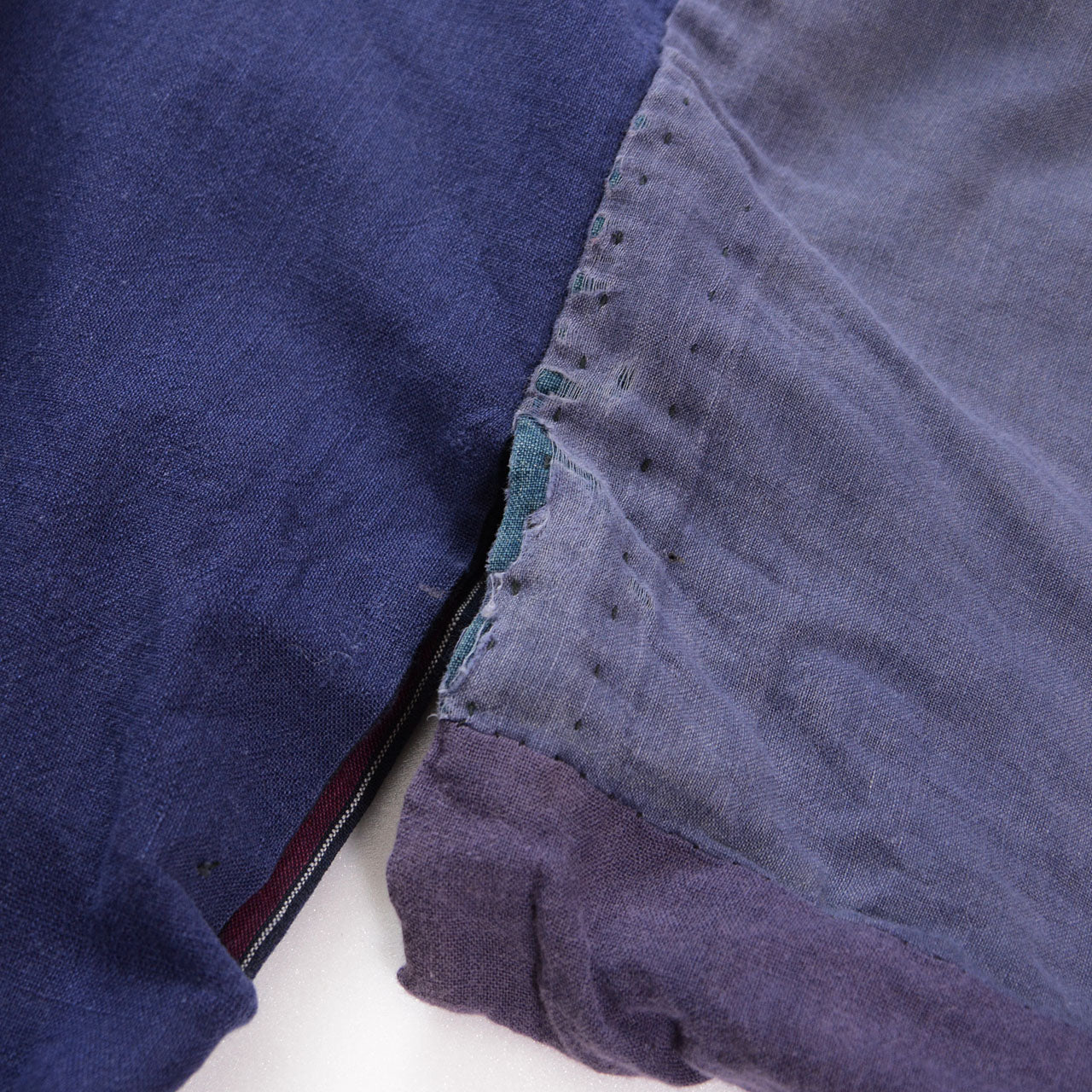 Abrasion at the underarm of the reverse side, revealing indigo plain fabric