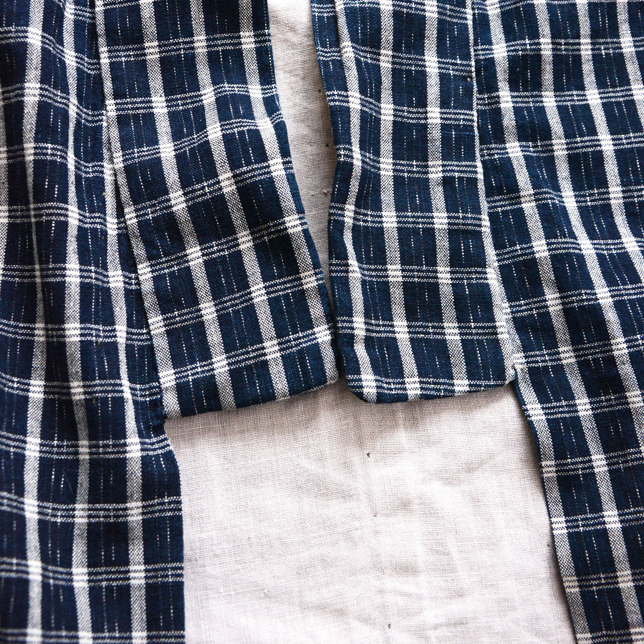 Collar detail of a vintage noragi jacket — indigo check cotton with contrasting inner fabric, hand-stitched edge, early Showa era Japan vintage