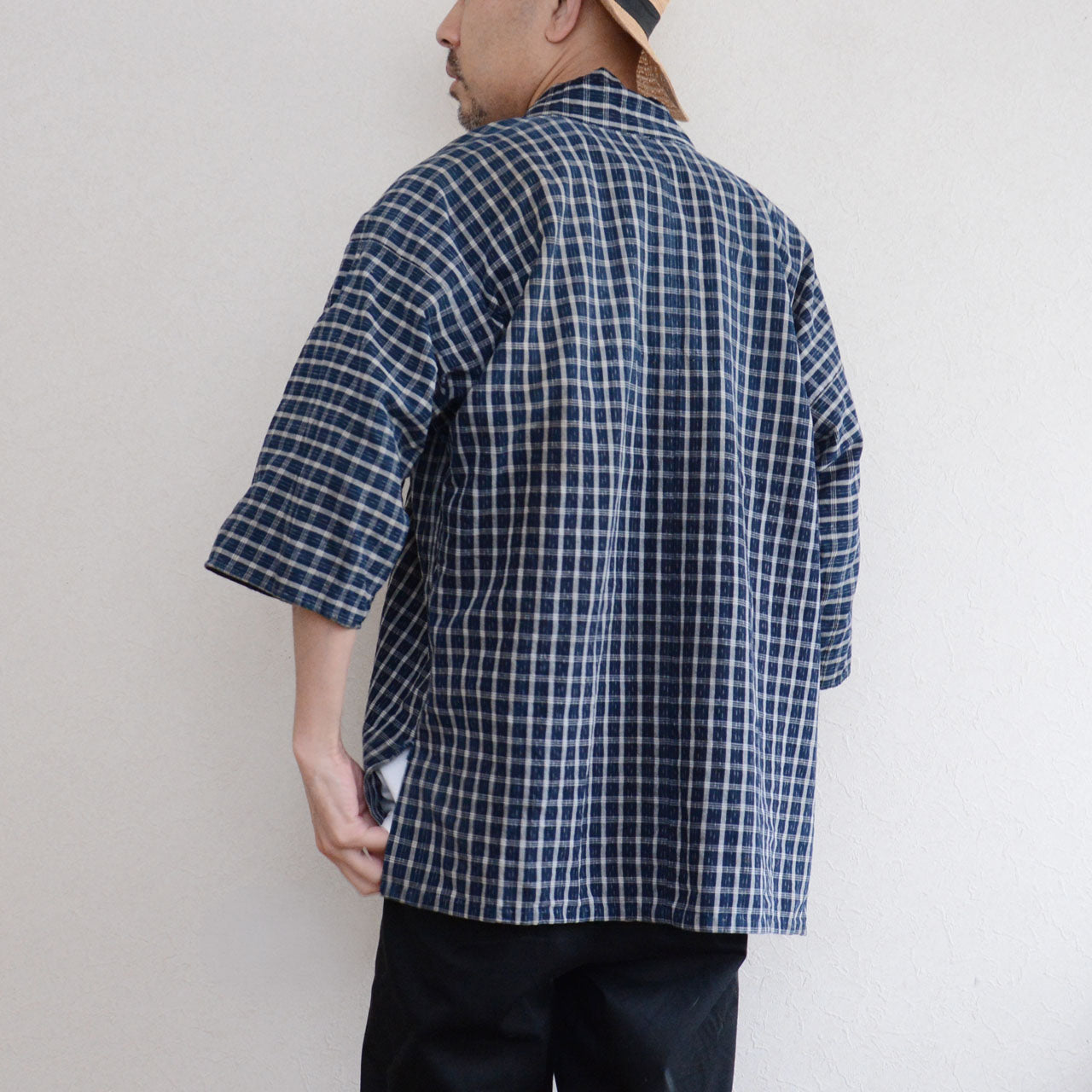 Vintage noragi jacket worn by a male model, back view — indigo-dyed cotton check, early Showa era Japan vintage
