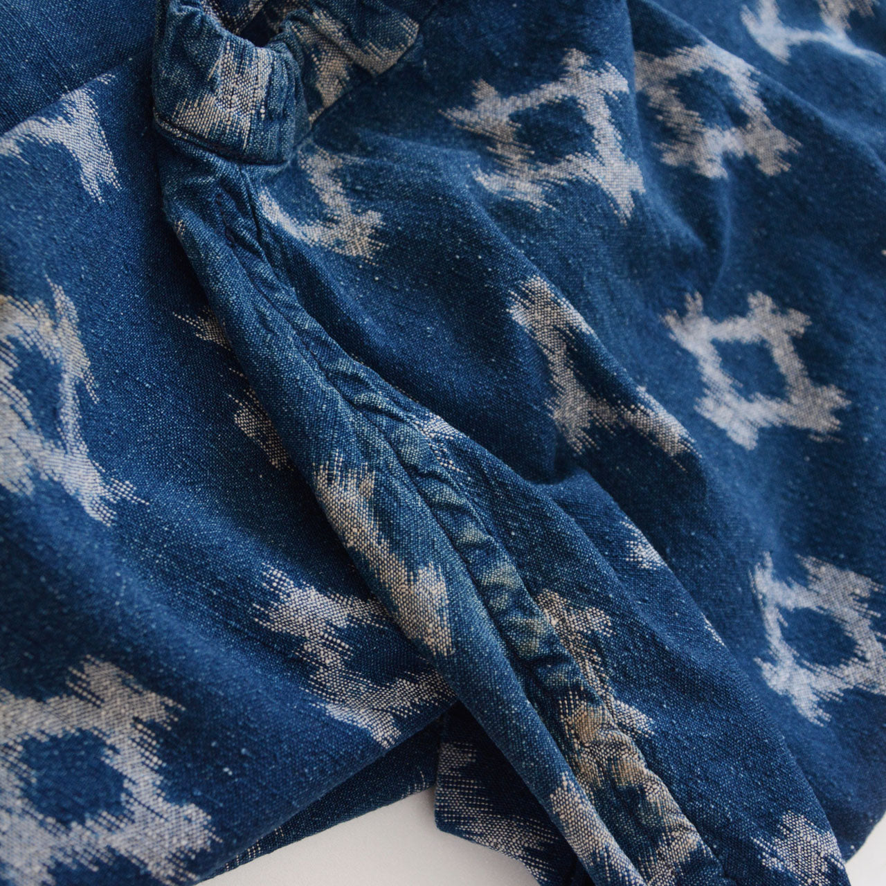 Puckering detail on sleeve of indigo kasuri noragi jacket, kasuri cotton texture, Japan vintage