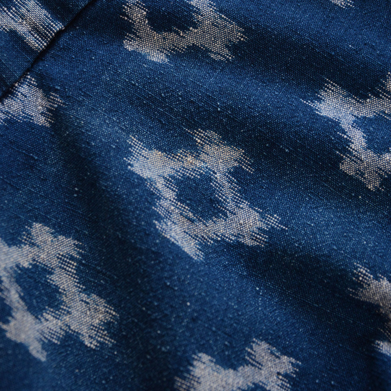 Close-up of indigo kasuri cotton fabric, diamond ikat weave, Showa-era Japan vintage textile