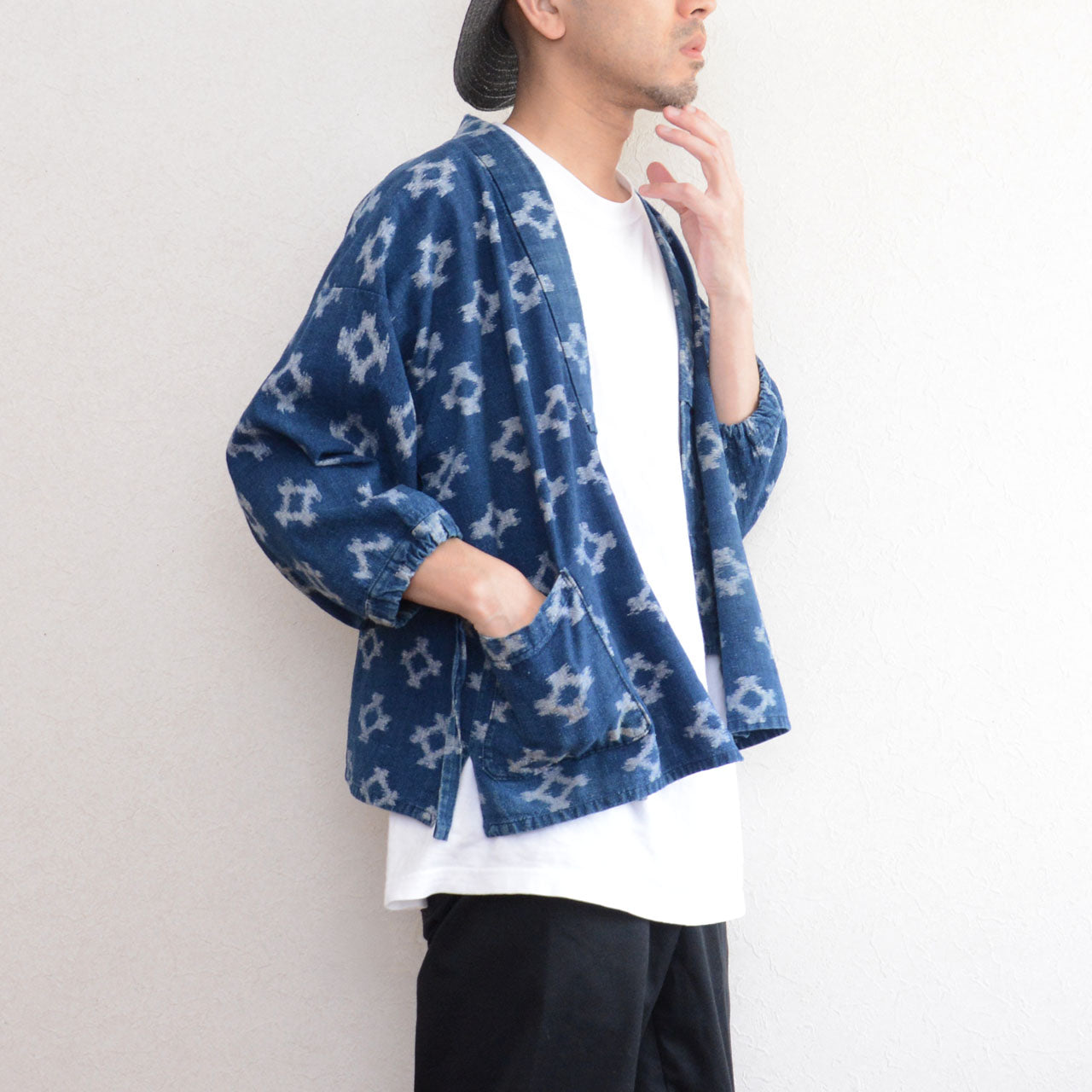 Model wearing indigo kasuri noragi jacket, upper body, diamond ikat cotton, Japan vintage workwear