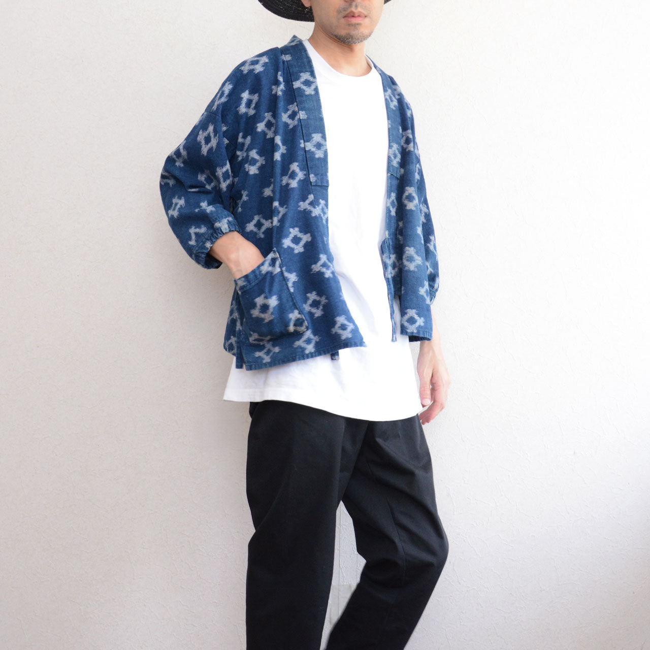 Model wearing indigo kasuri noragi jacket with hand in pocket, upper body to knee, Japan vintage styling