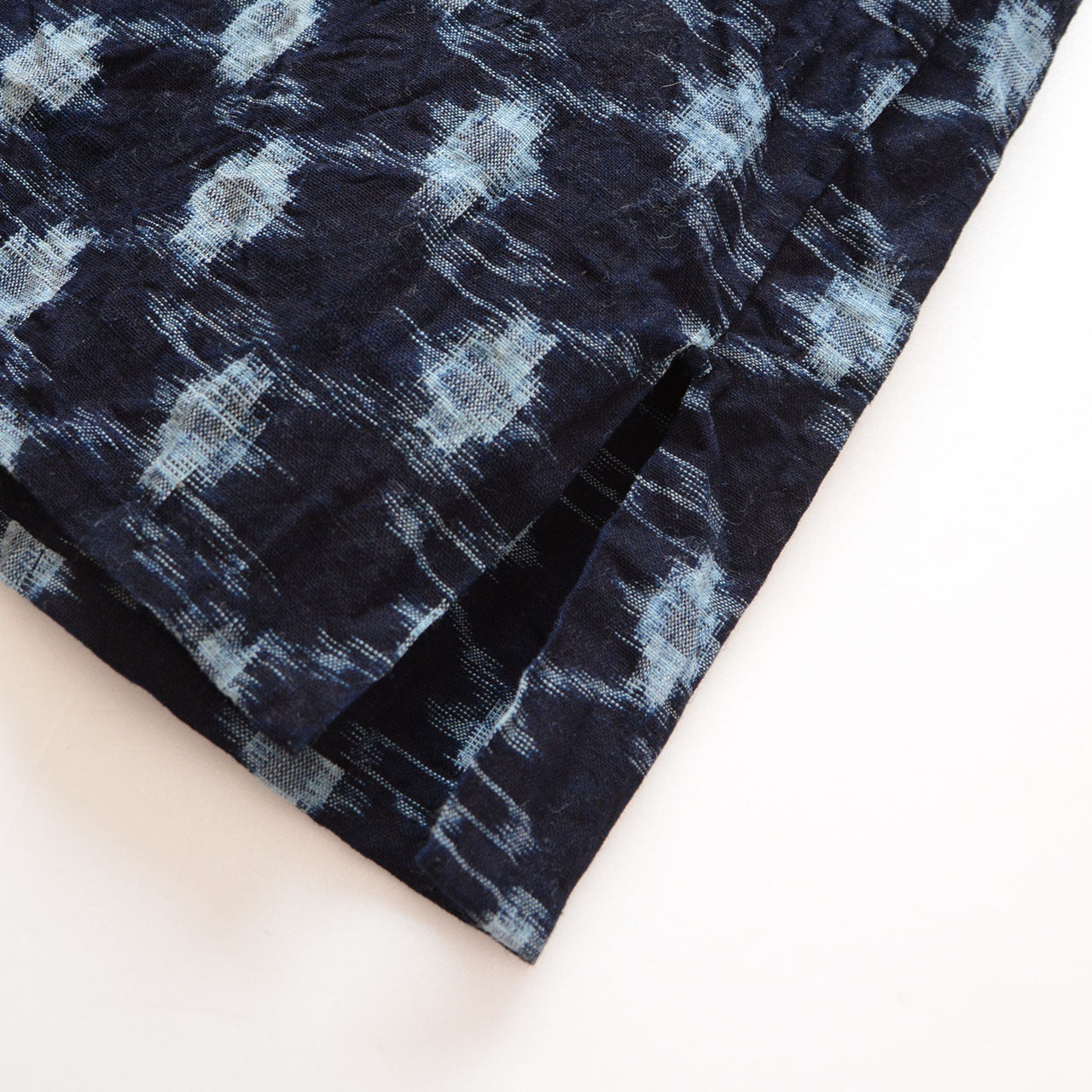 Hem and side slit detail, indigo kasuri noragi jacket, navy cotton ikat pattern, Showa era Japan vintage