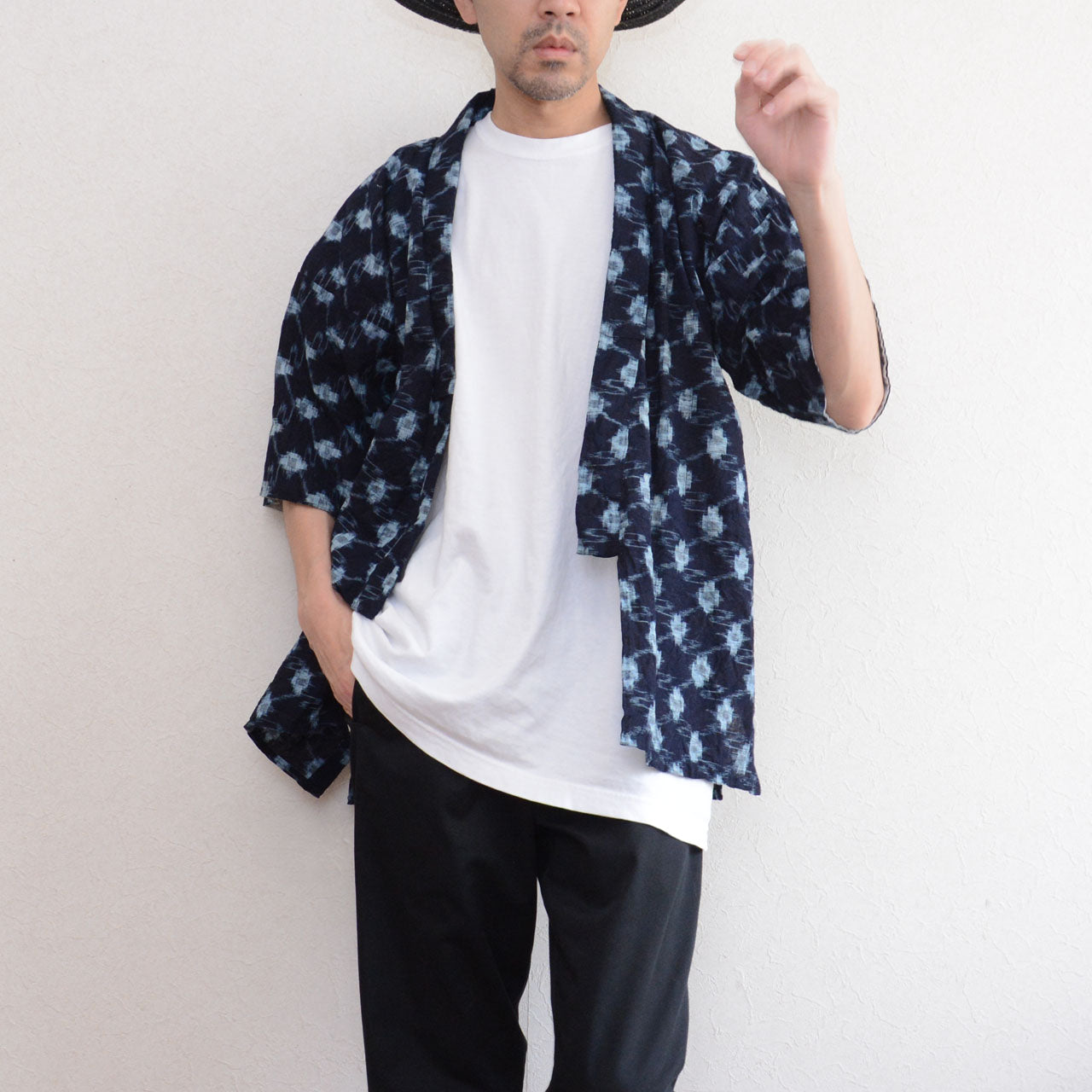 Indigo kasuri noragi jacket worn open over white tee and black trousers, men, straw hat, Showa era Japan vintage