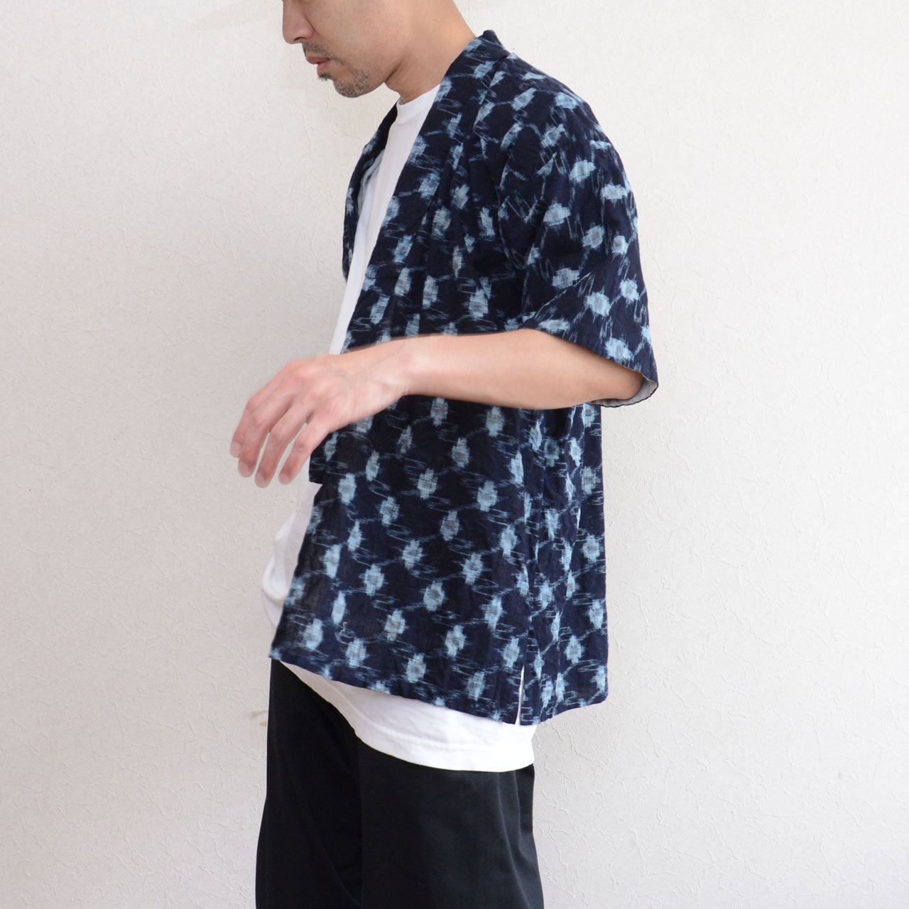 Indigo kasuri noragi jacket, side view, worn over white tee and black trousers, men, short sleeve, open front, Showa era Japan vintage