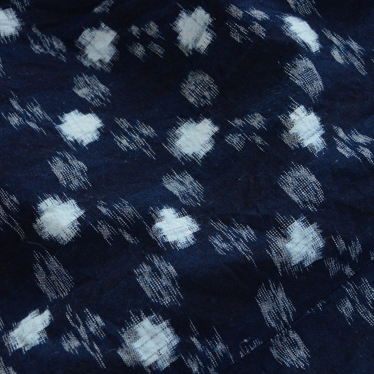 Indigo cotton fabric of a mid-Showa noragi uwappari jacket with large and small white kasuri motifs