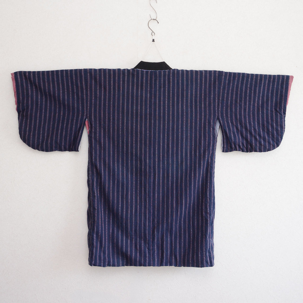 Back of a Japanese vintage noragi jacket in dark indigo striped cotton