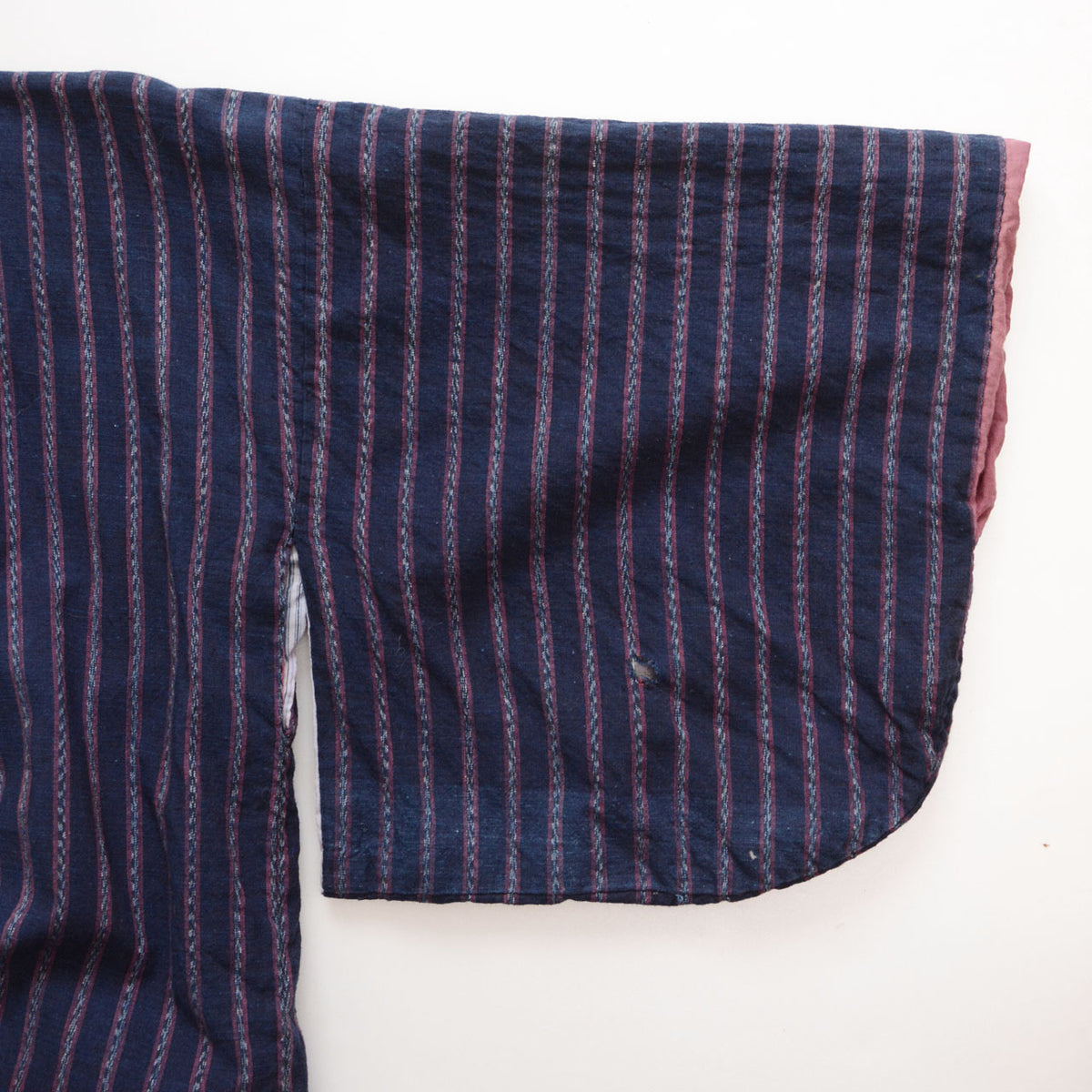 Close-up of indigo striped cotton and a seam on a Japanese vintage noragi jacket