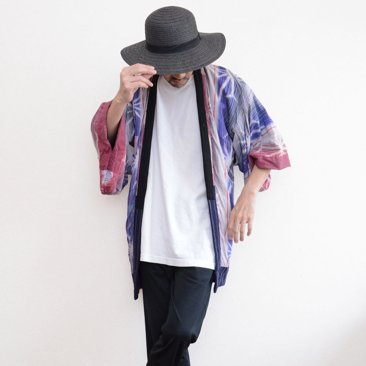 Front view of a model wearing a Japanese vintage noragi jacket with pink, blue, and white patterned cotton panels