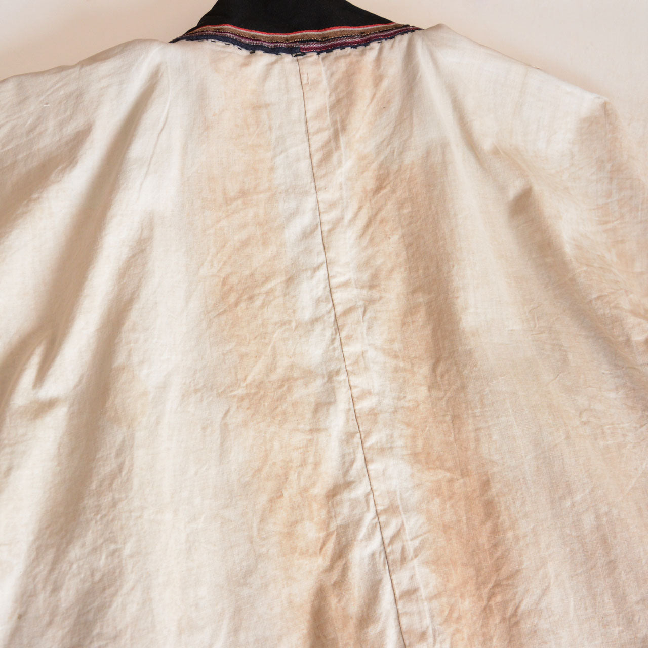 Indigo cotton outerwear with natural signs of age and wear.