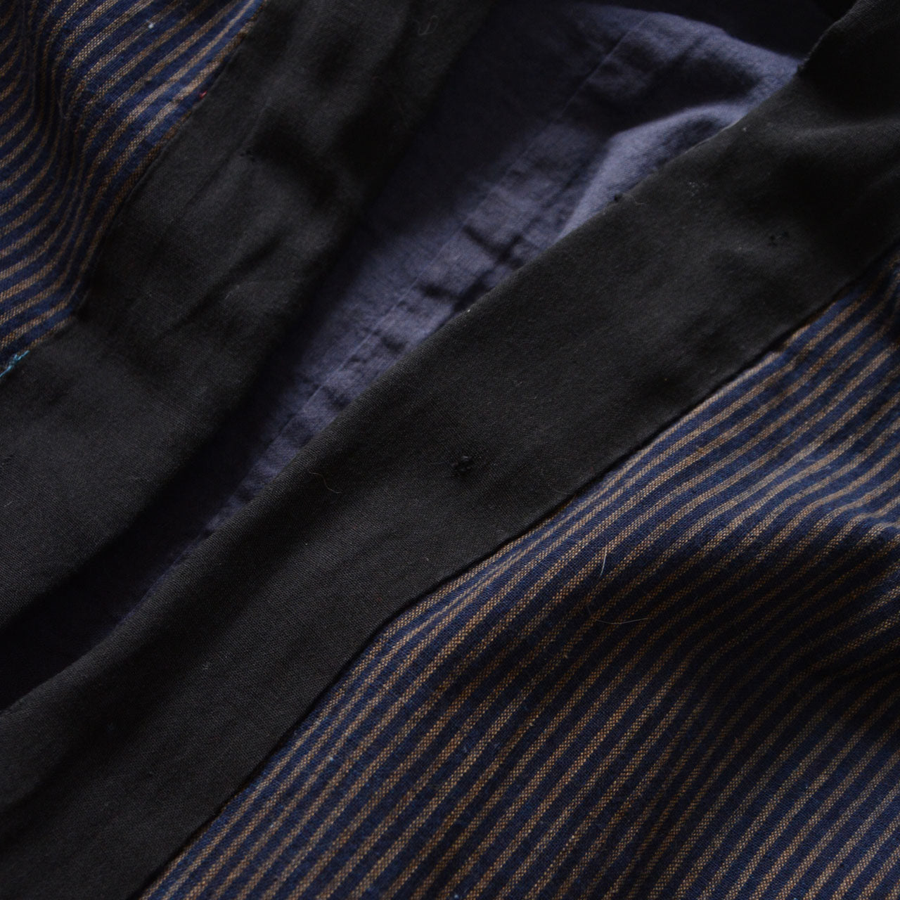 Traditional indigo-striped noragi jacket reflecting Japanese folk clothing culture