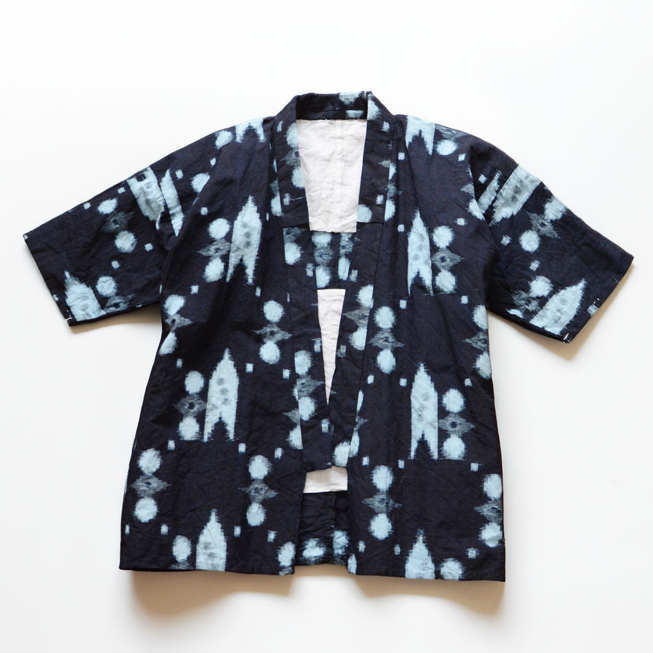 Vintage Japanese noragi jacket in indigo-dyed kasuri cotton, flat lay front view, mid-Showa era