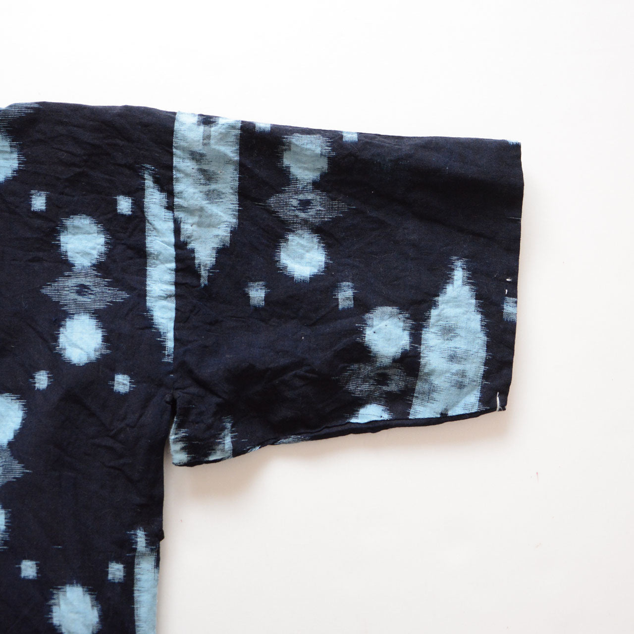 Sleeve detail of vintage Japanese noragi jacket, indigo kasuri cotton with geometric dot pattern, mid-Showa era Japan