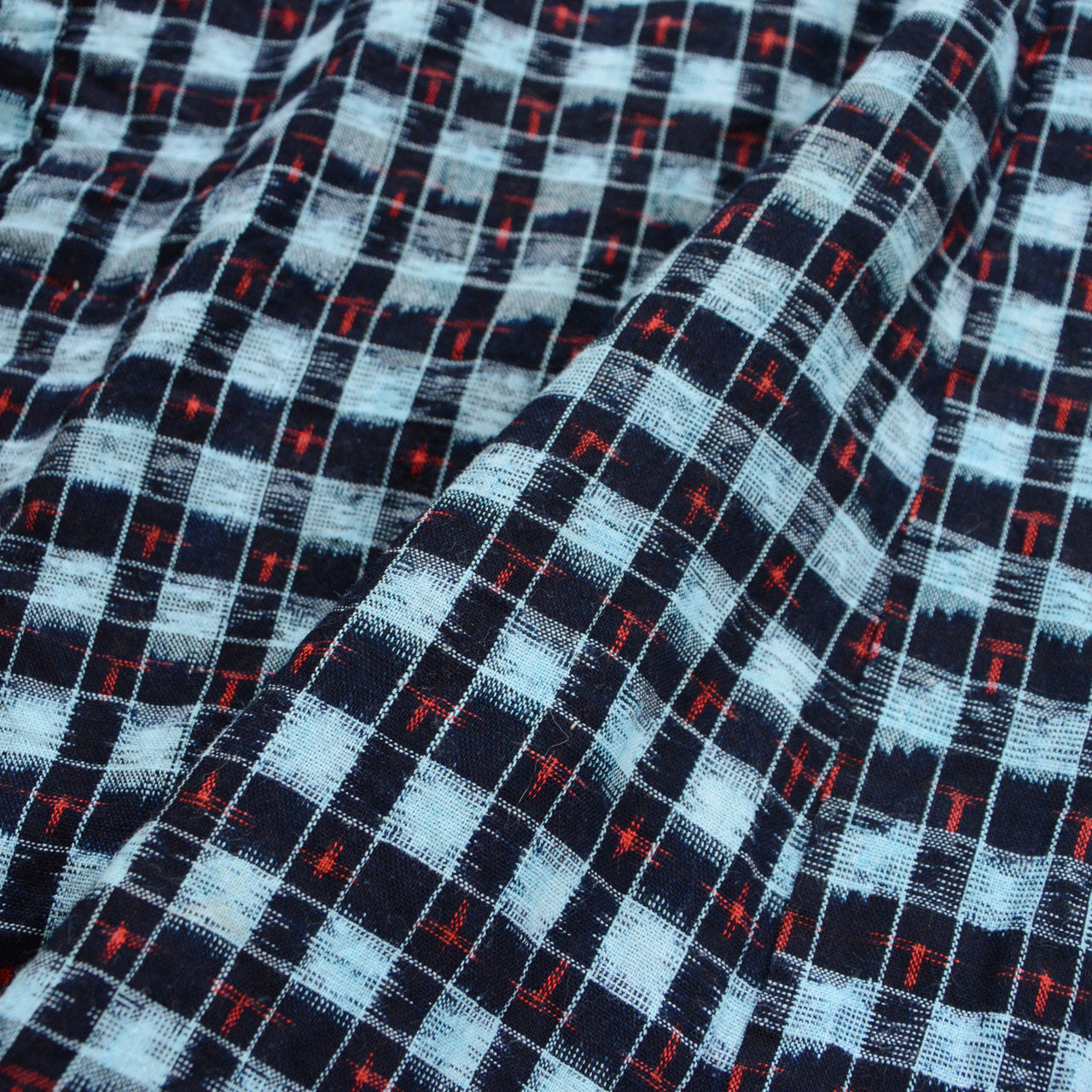 Close-up fabric detail of vintage Japanese noragi uwappari jacket, indigo-dyed check cotton weave, mid-Showa era, Tohoku Japan