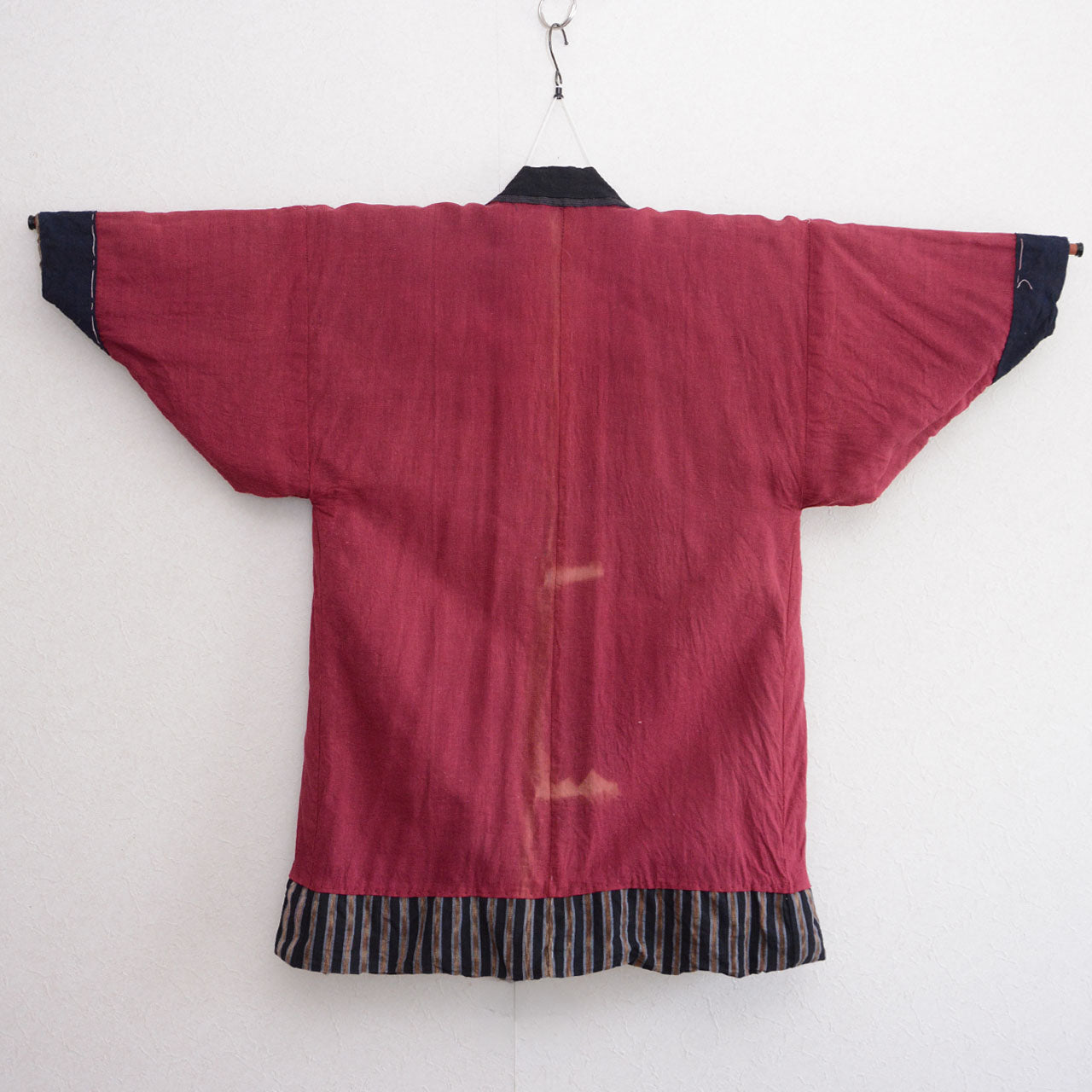 Vintage noragi jacket, inner side (crimson red cotton), on kimono hanger, back view — mid Showa era, Tohoku, Japan vintage