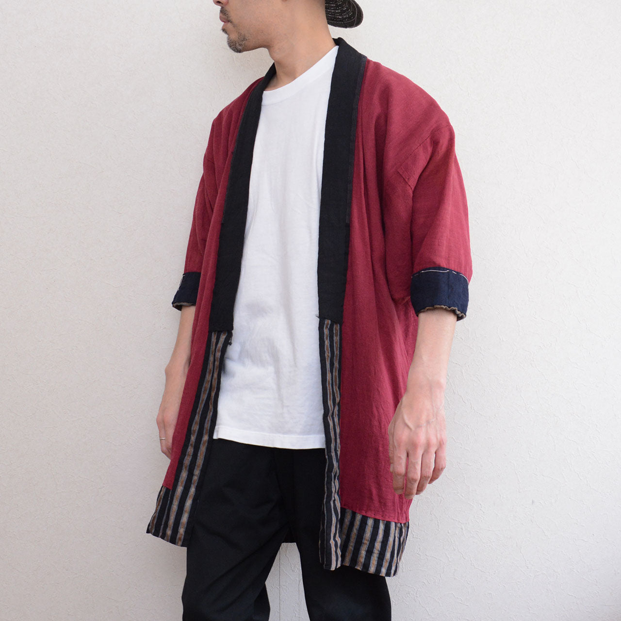 Vintage noragi jacket worn by male model, front-side angle — gradient stripe outer, mid Showa era, Tohoku, Japan vintage