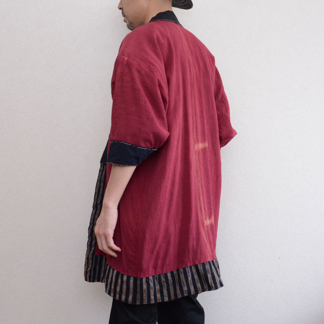 Vintage noragi jacket worn by male model, back-side angle — gradient stripe outer, mid Showa era, Tohoku, Japan vintage