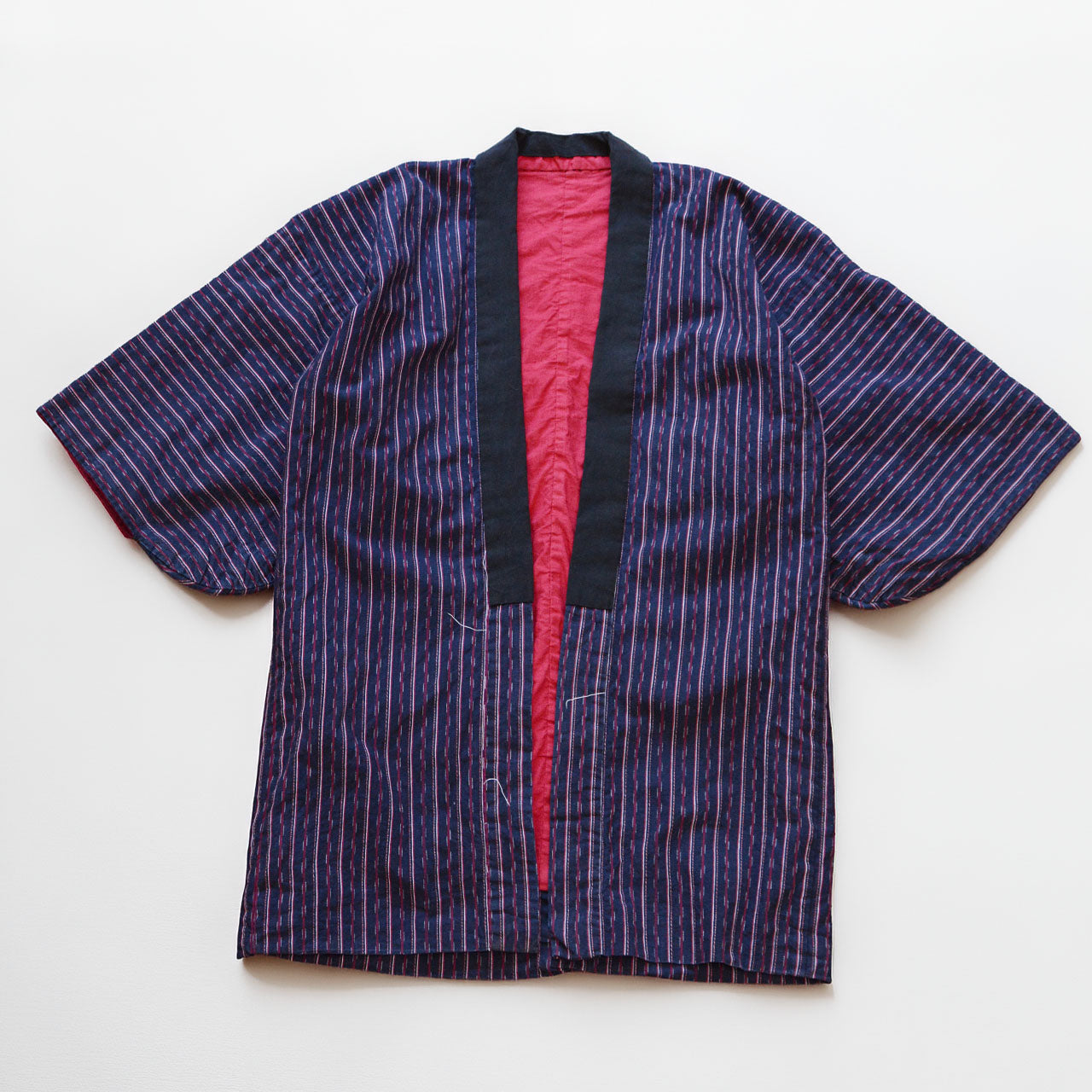 Navy cotton stripe noragi jacket, laid flat, front view