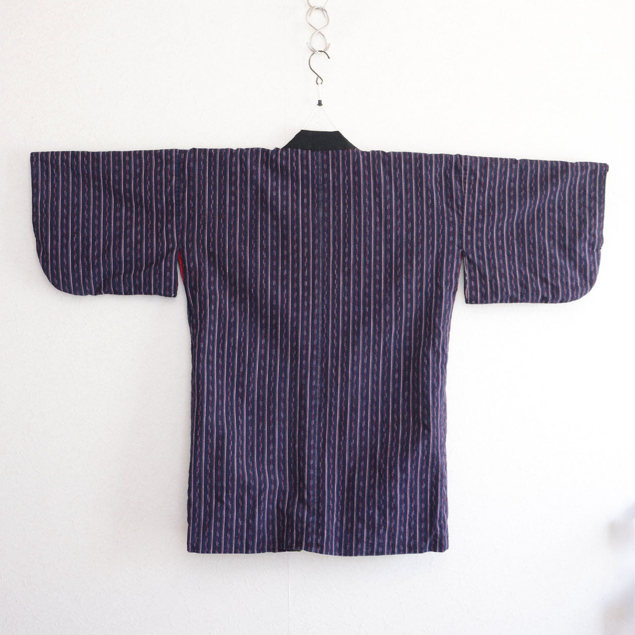 Navy cotton stripe noragi jacket on kimono hanger, back view