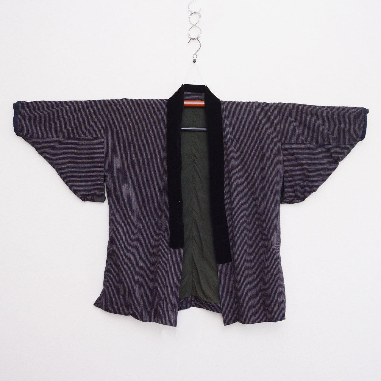 Vintage Japanese noragi jacket on kimono hanger, vertical stripe cotton with black velvet collar, front view, early Showa era