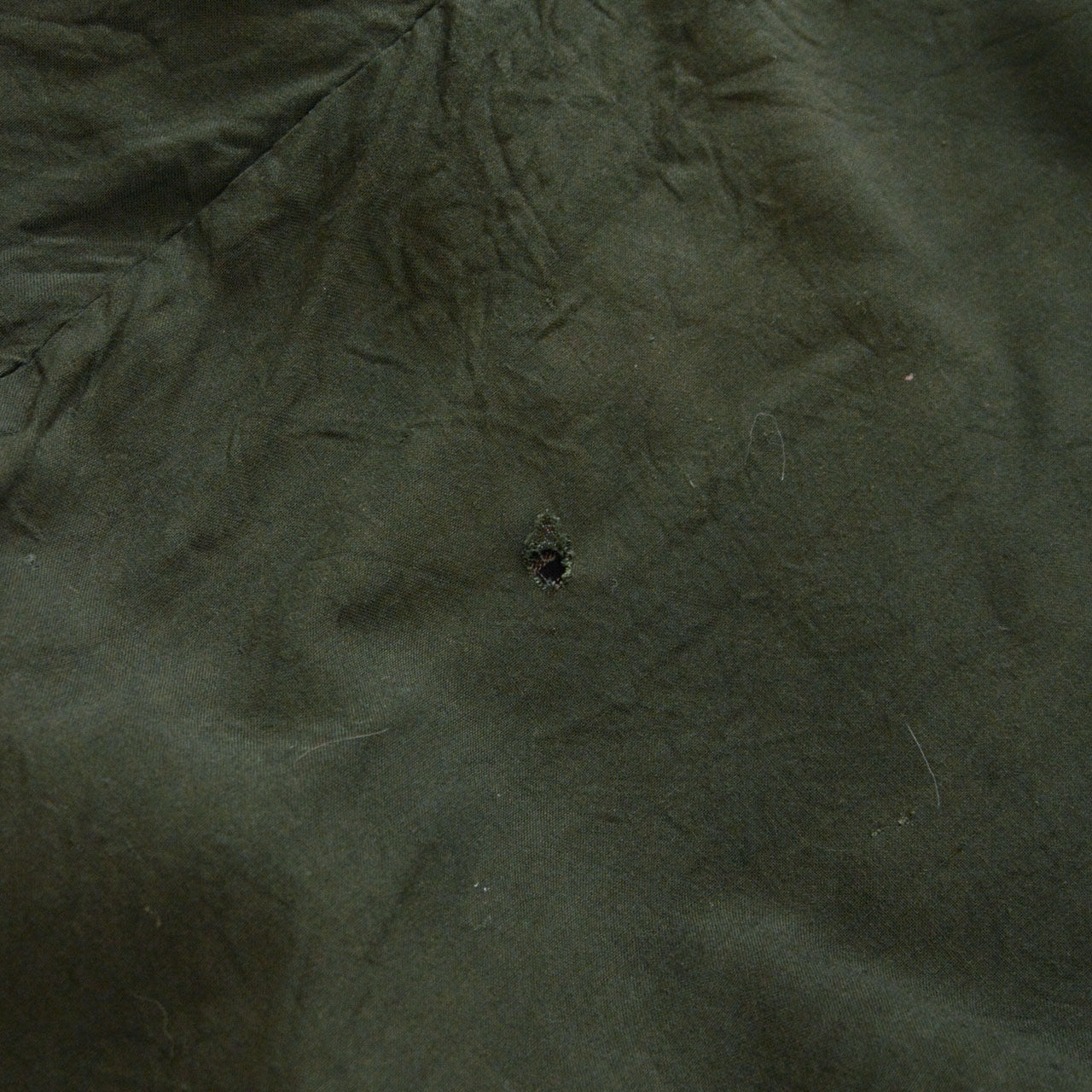 Damage to green cotton lining of vintage Japanese noragi jacket, early Showa era