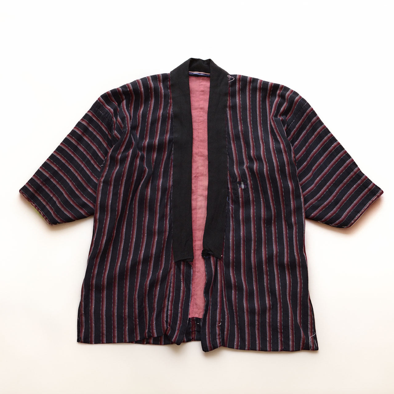 Japanese vintage noragi with dark black-to-navy striped cotton fabric and a salmon-pink lining