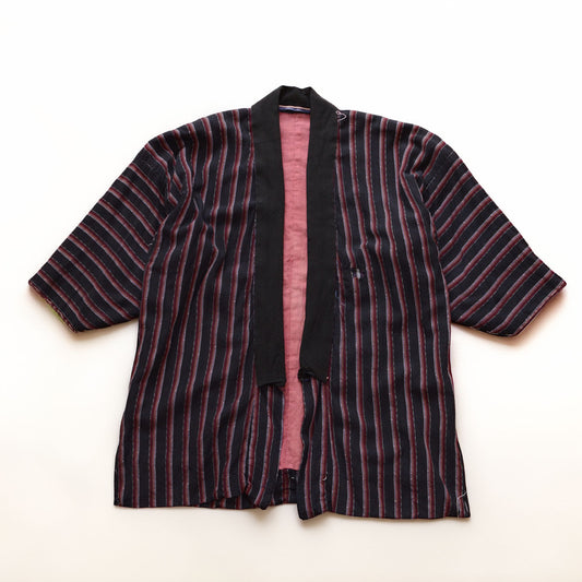 Japanese vintage noragi with dark black-to-navy striped cotton fabric and a salmon-pink lining