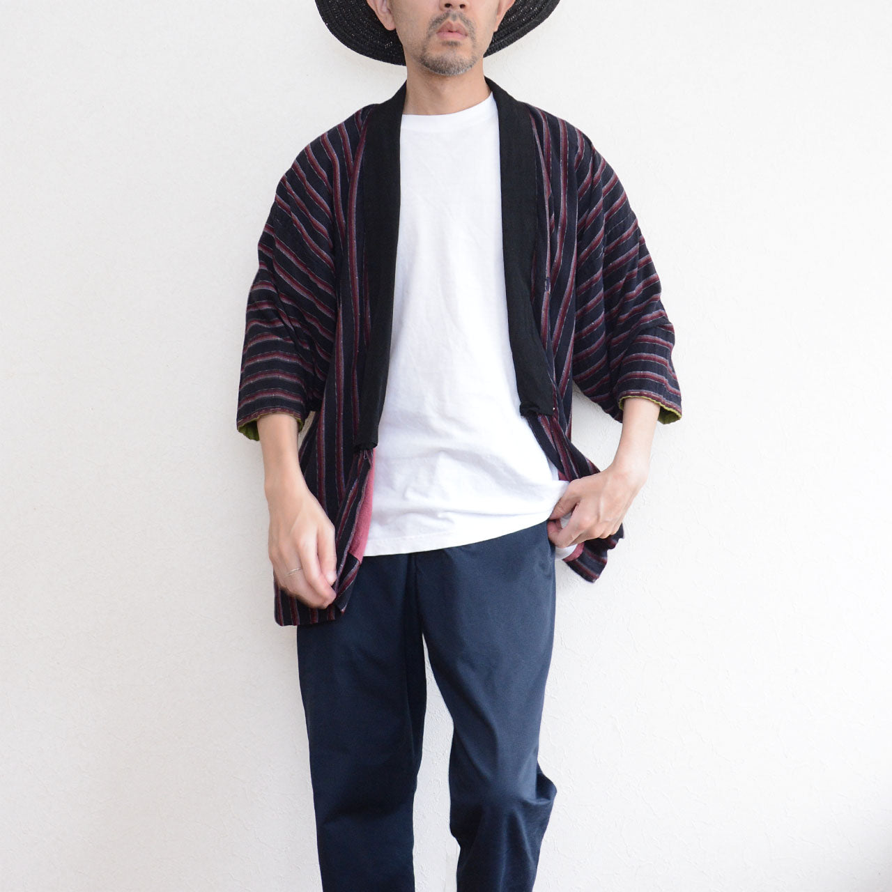 Front view of a Japanese vintage striped noragi worn with a white T-shirt and dark trousers