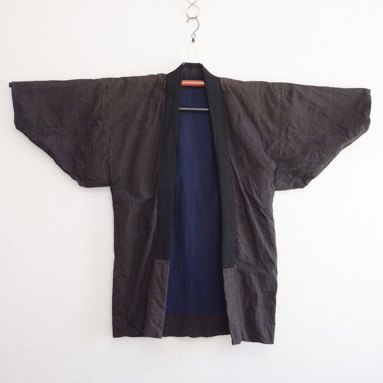 Vintage Japanese noragi work jacket, striped cotton exterior with indigo plain lining, mid-Showa era Tohoku — front view, kimono hanger