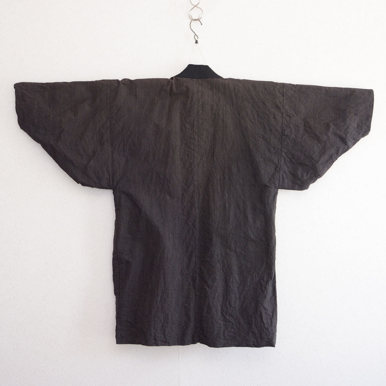 Vintage Japanese noragi work jacket, striped cotton exterior with indigo plain lining, mid-Showa era Tohoku — back view, kimono hanger