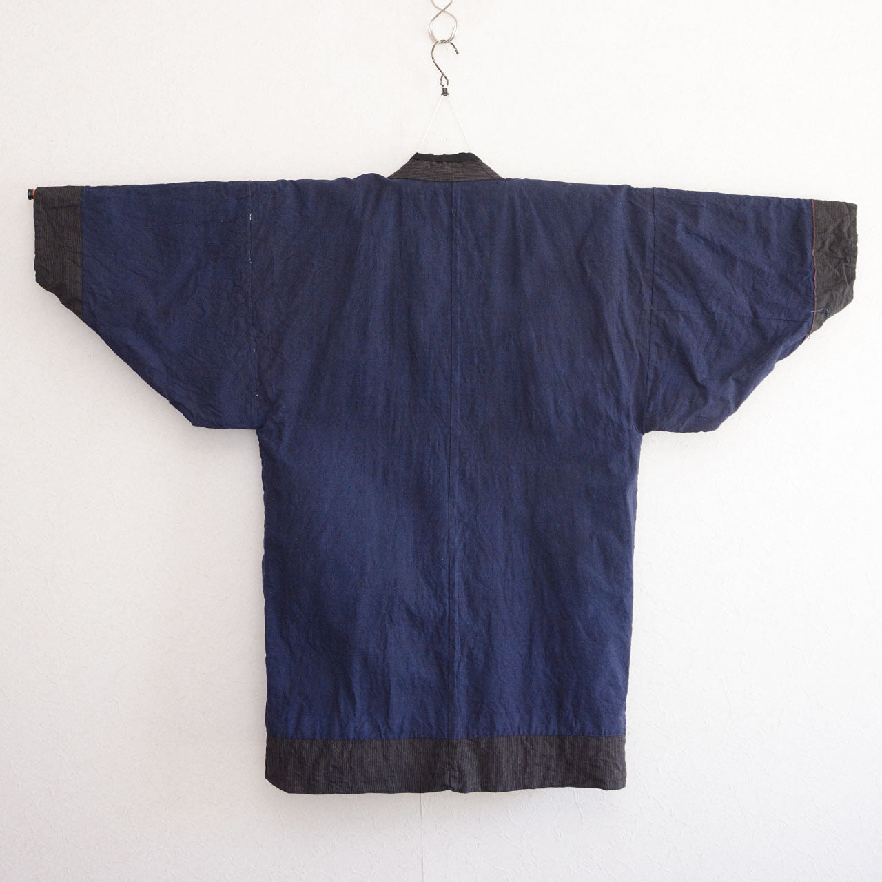 Vintage Japanese noragi work jacket, indigo plain lining interior, mid-Showa era Tohoku — back view, kimono hanger