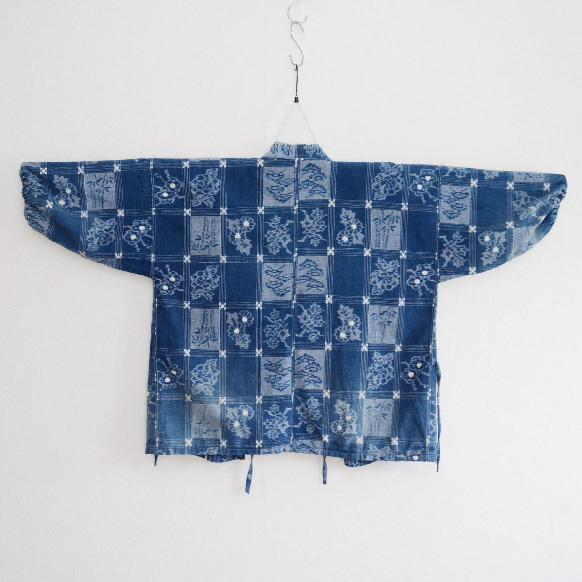 Indigo cotton uwappari noragi jacket with alternating dark and pale blue grid panels and botanical motifs