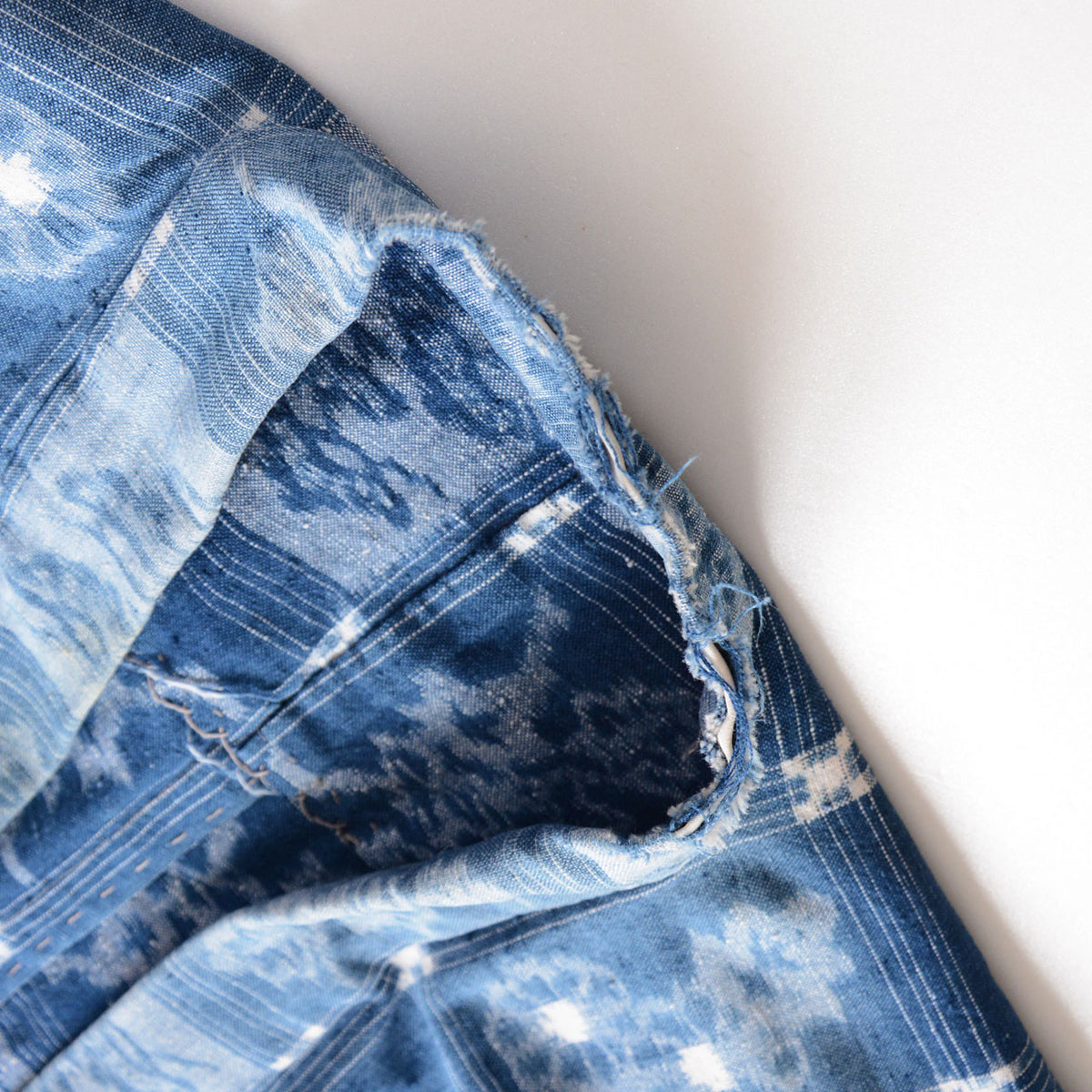 Fraying along the collar of a vintage indigo cotton uwappari noragi jacket