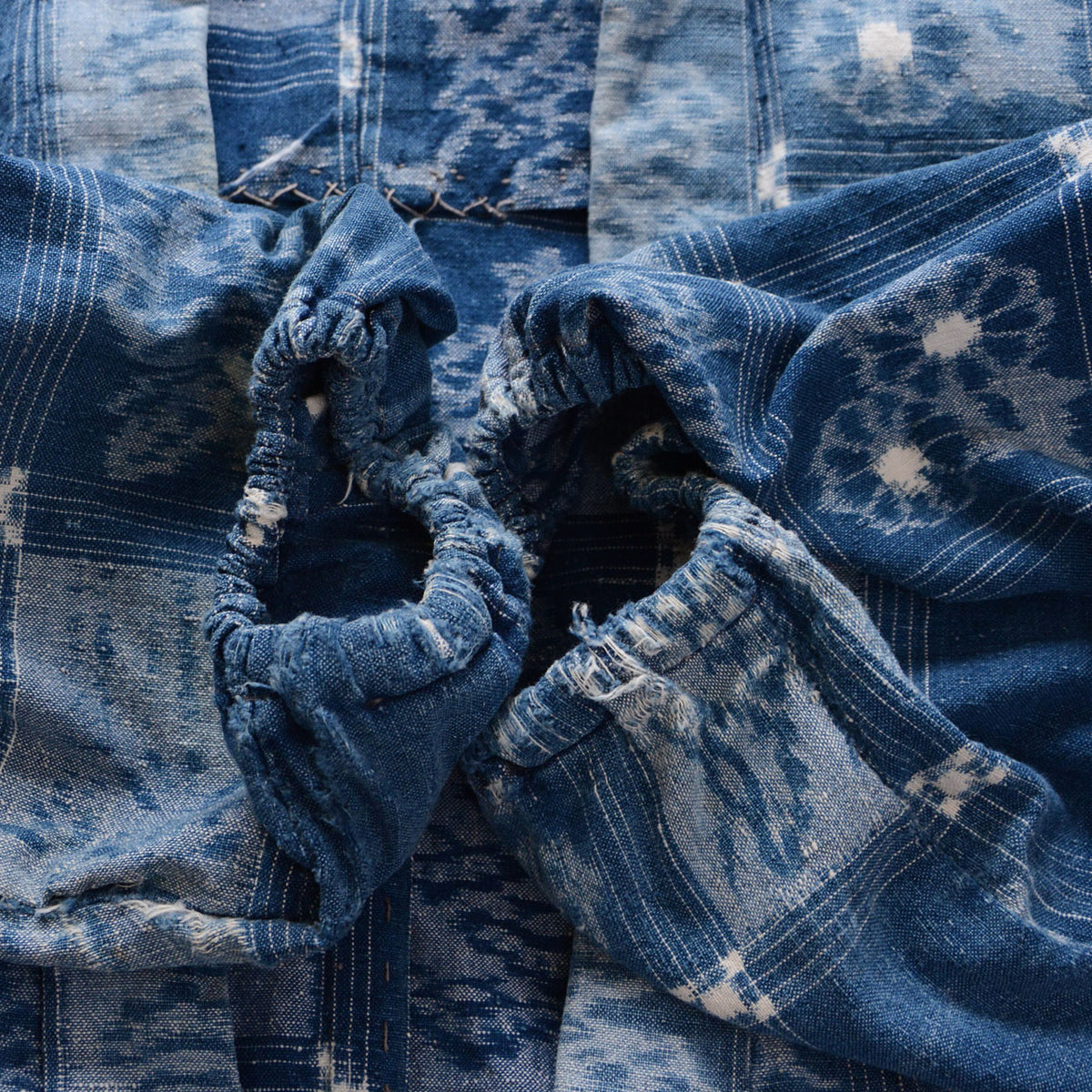Worn and frayed elasticated cuffs of a vintage indigo cotton uwappari noragi jacket
