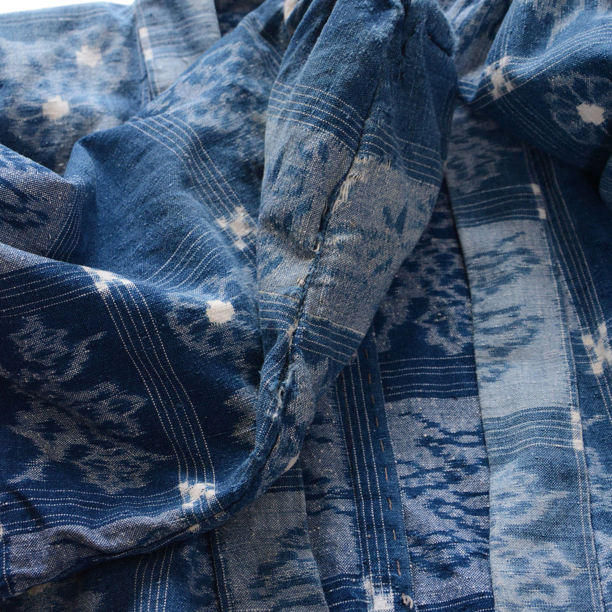 Sleeve damage and fraying on a vintage indigo cotton uwappari noragi jacket
