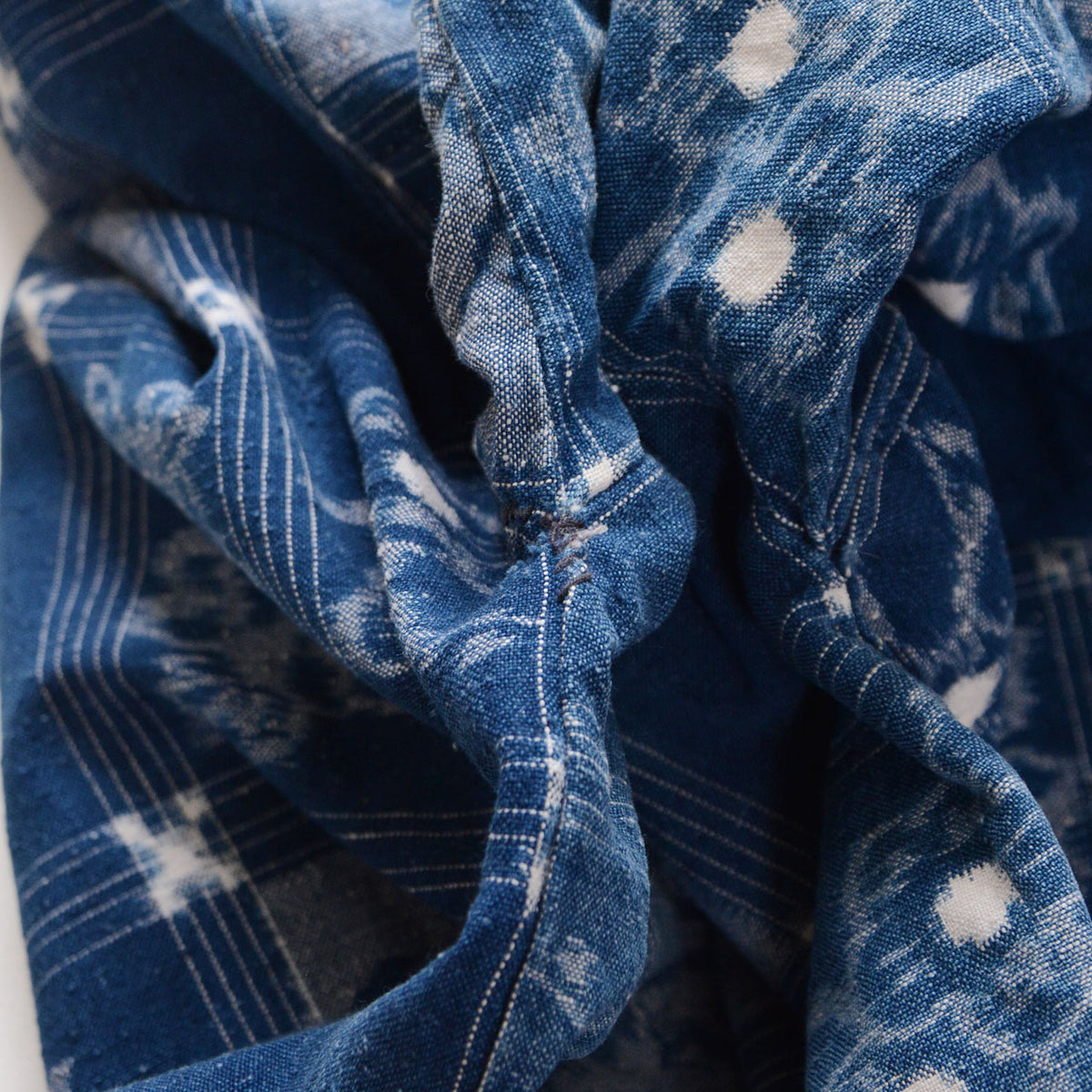 Underarm restitching on a vintage indigo cotton uwappari noragi jacket