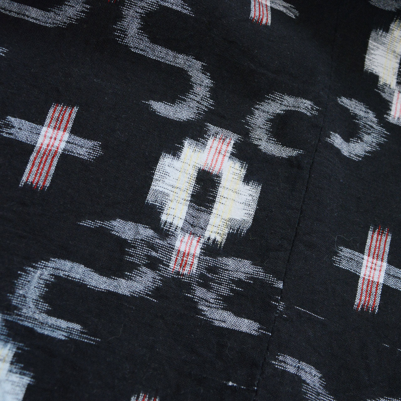 Cross ikat kasuri pattern close-up, white and red on dark navy cotton, Showa era Japanese vintage noragi fabric