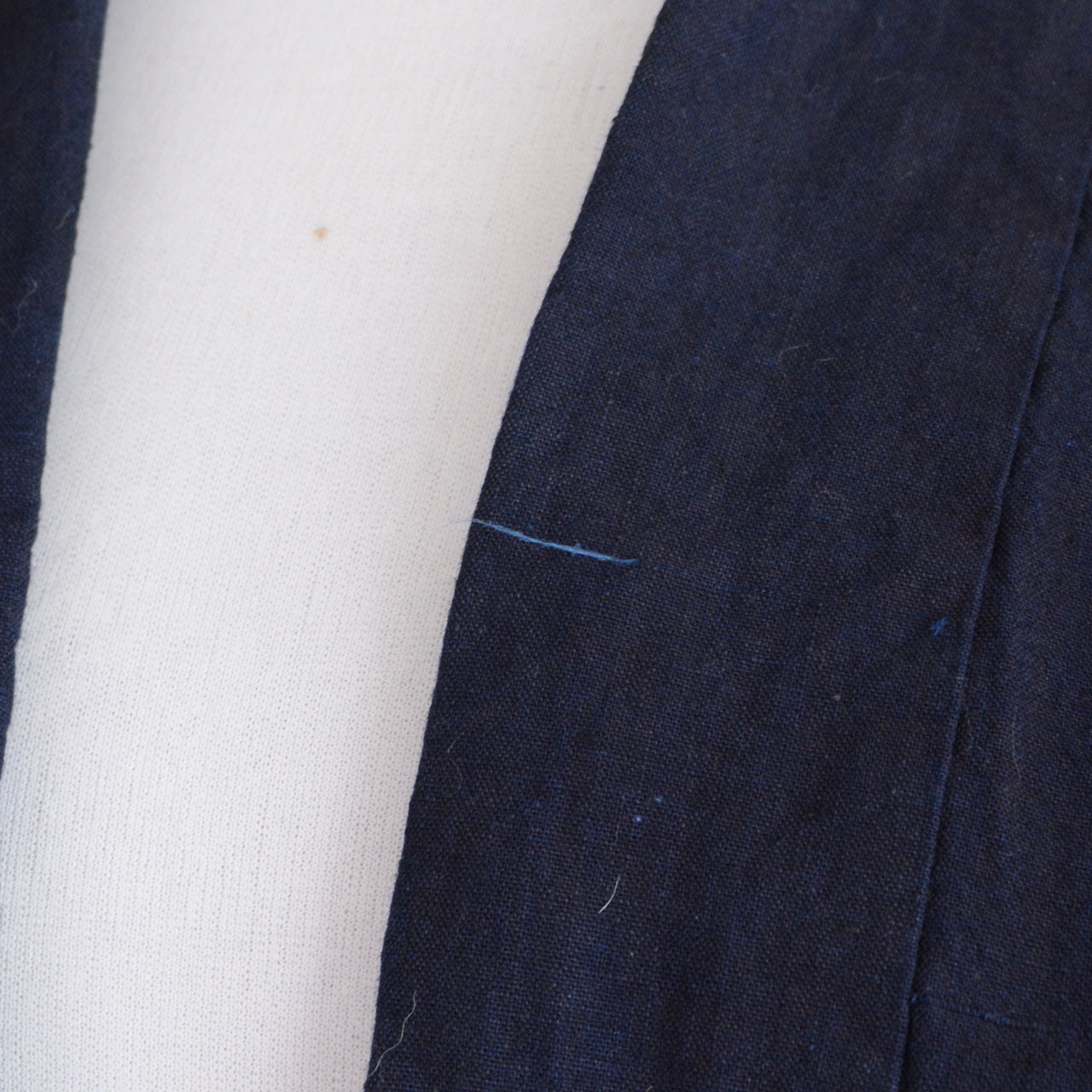An indigo-dyed cotton noragi reflecting traditional Japanese clothing construction.