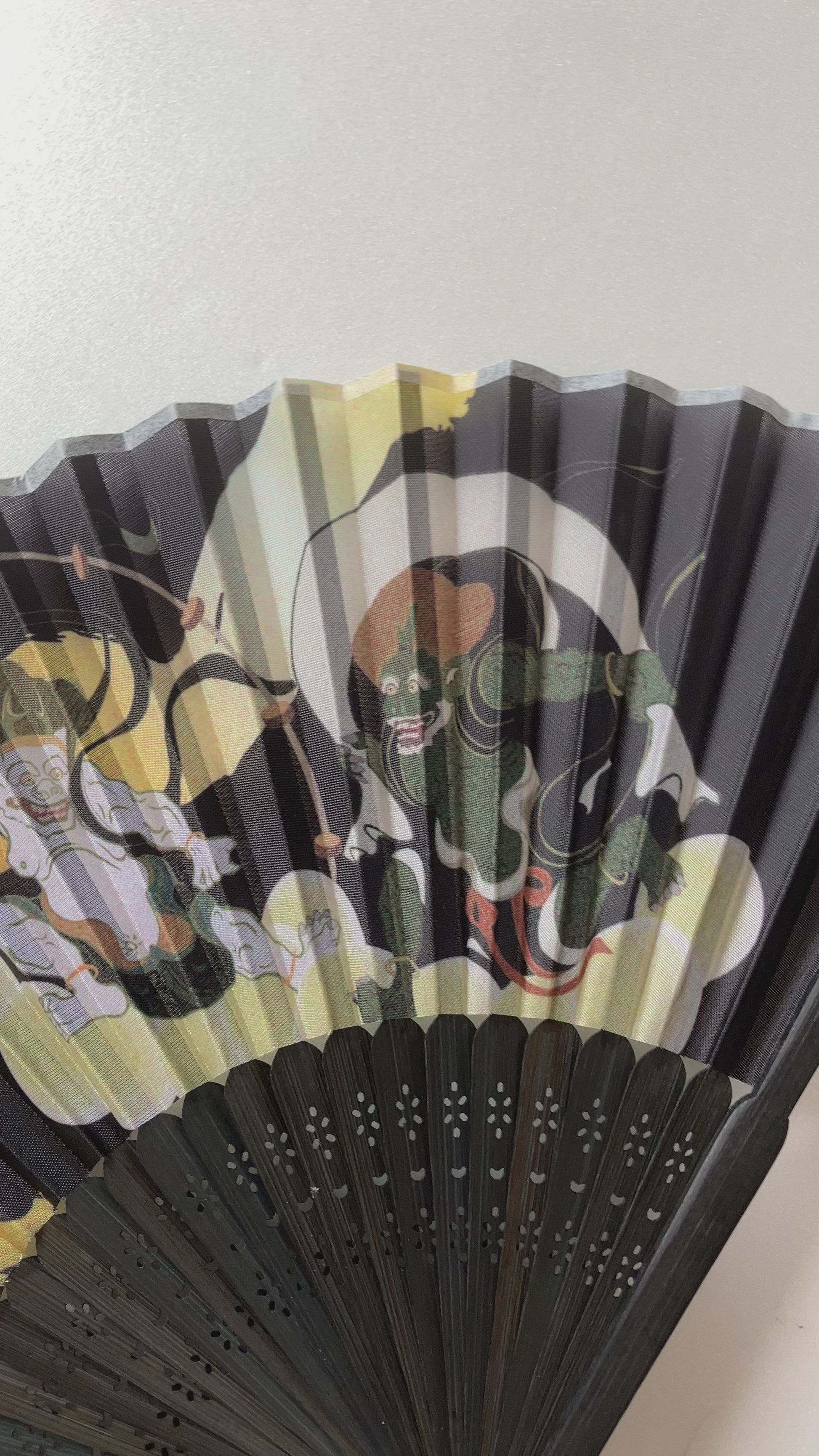 Close-up video of traditional bamboo ribs and printed polyester surface of Japanese fan
