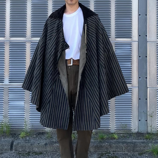 Indigo travel cloak in motion, showing vintage fabric texture and sleeve-less design
