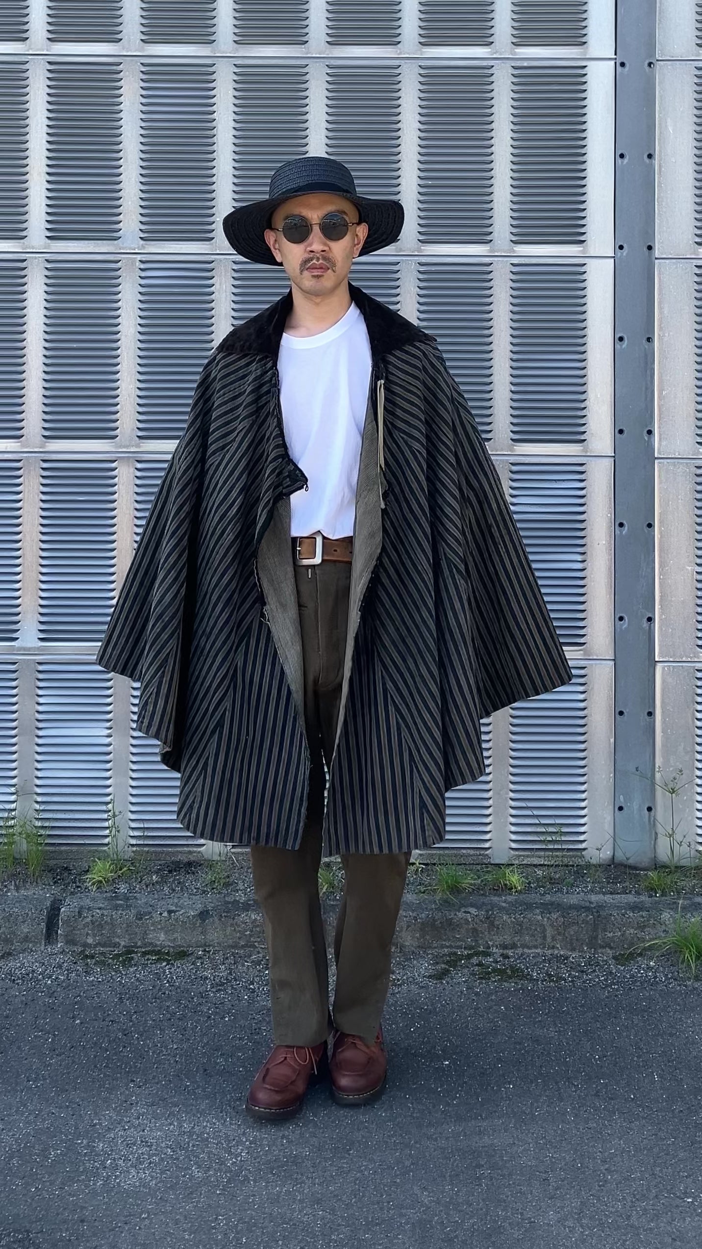 Indigo travel cloak in motion, showing vintage fabric texture and sleeve-less design