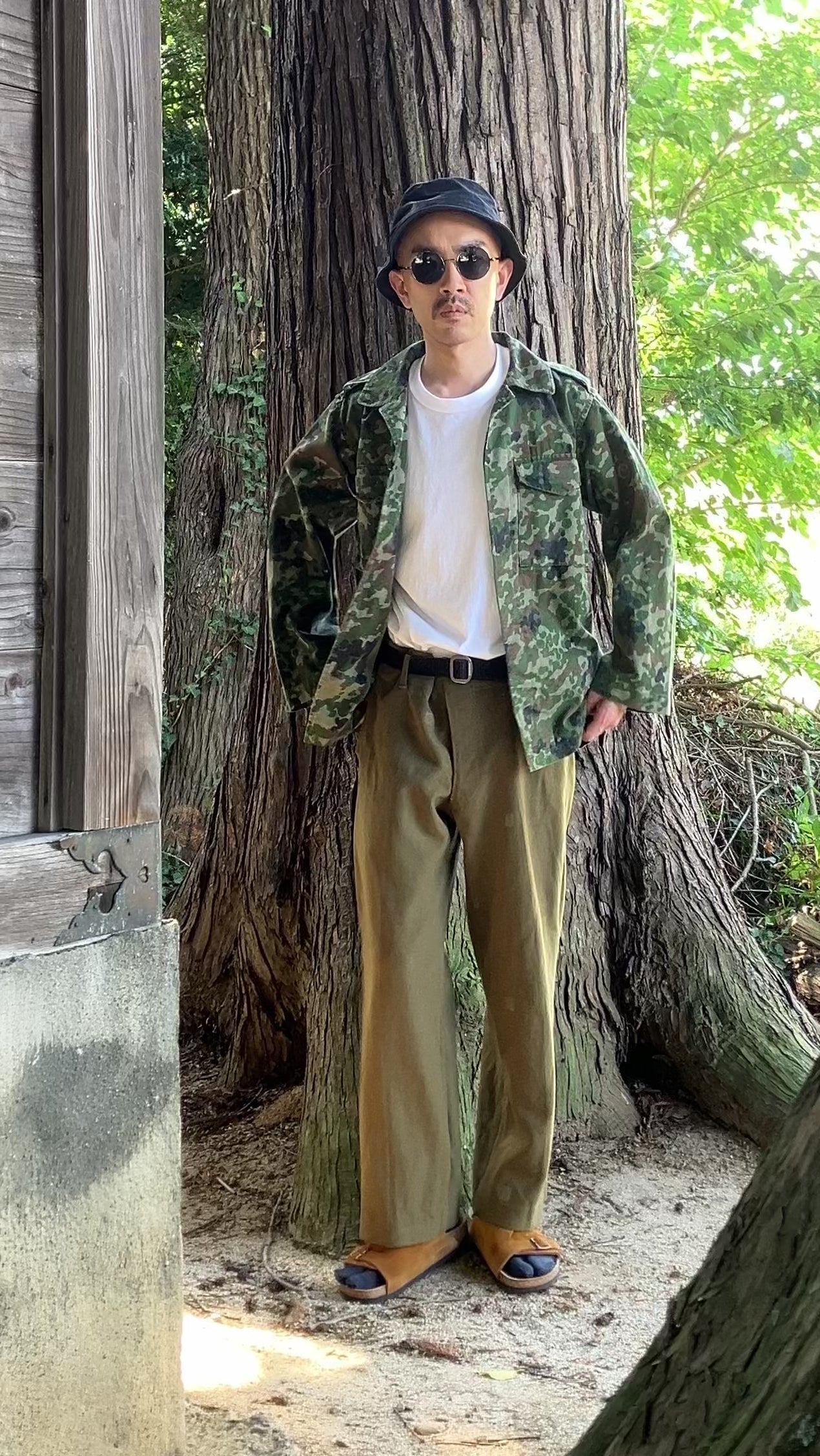 1990s JGSDF Type II camouflage jacket showcased with casual styling, including white T-shirt and Birkenstock Zurich sandals