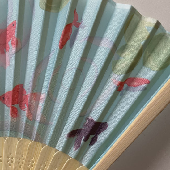 Visual showcase of Japanese summer fan featuring swimming goldfish artwork