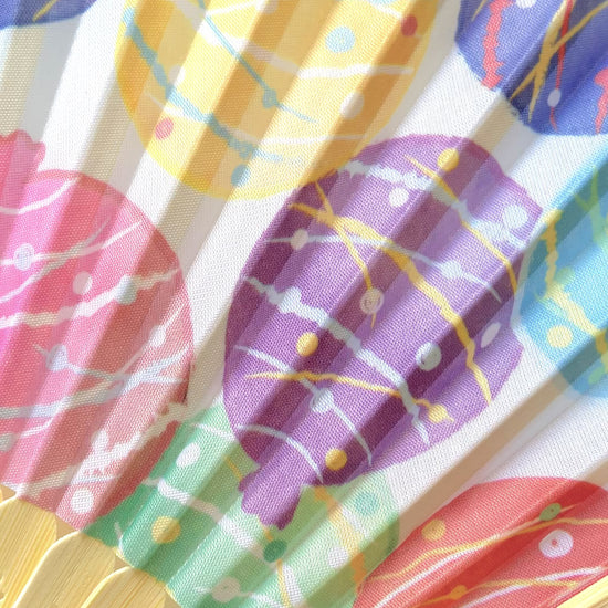 Stylish folding fan in use during summer