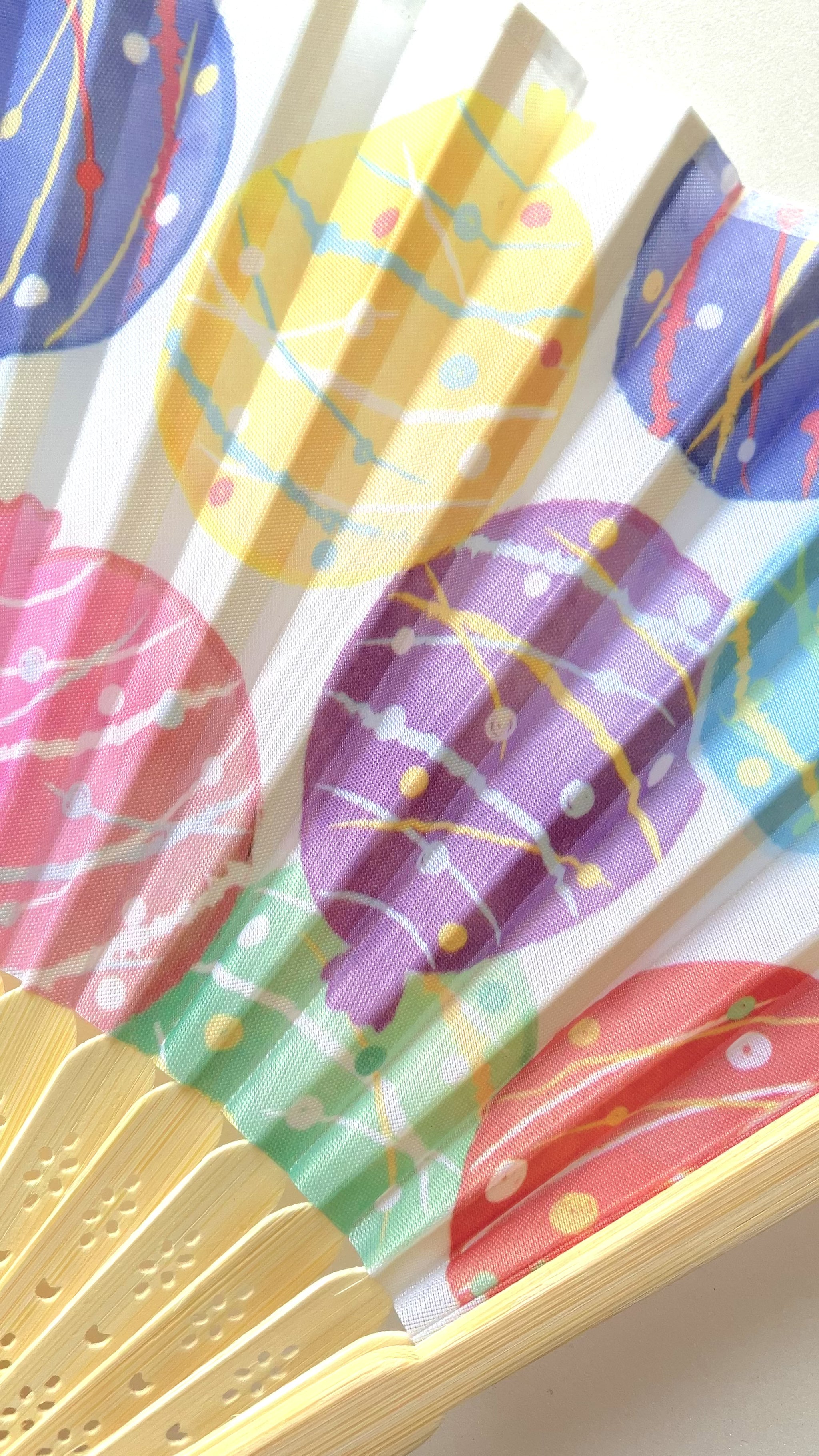 Stylish folding fan in use during summer