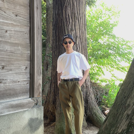 Model wearing vintage Japanese straight-leg wool trousers with T-shirt and sandals